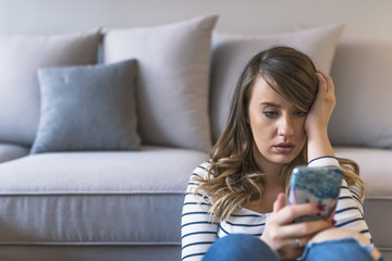 Portrait of young sad annoyed woman, receiving bad sms