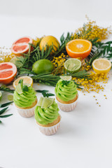 spring cupcake on a white background with flowers and fruits aro