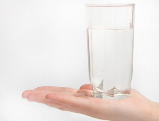 Woman hand with glass of water isolated on white background