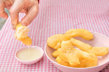 Youtiao deep fried dough stick a kind of Chinese flour sweet meal Chinese breakfast and Thailand called Pa Tong Ko eat with coffee or soy milk delicious morning street food dessert