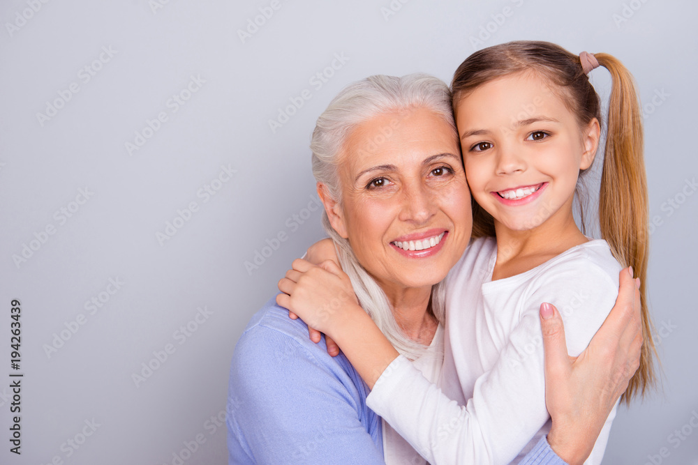 Sticker close up portrait of cute small lovely granddaughter and her charming nice kind granny they are hugg