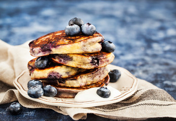 Stack of freshly prepared blueberry ricotta pancakes with fresh berries, yogurt and honey - obrazy, fototapety, plakaty