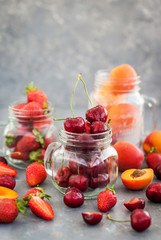 Fresh ripe summer cherry, strawberry and apricots