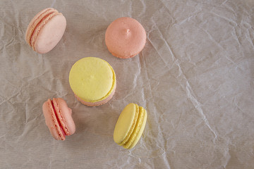 French macaroons on crumpled paper with copy space top view