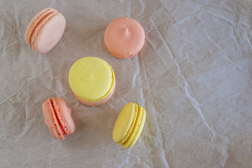 French macaroons on crumpled paper with copy space top view