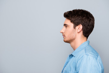 Advertisement concept, side view half face profile with copy space of perfect man standing over gray background