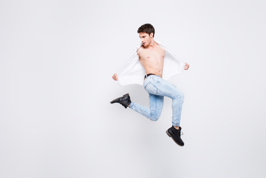Free celebrate legs happiness people person win winner luck vogue concept. Full-length full-size portrait of handsome attractive with haircut wearing denim trousers guy isolated on gray background