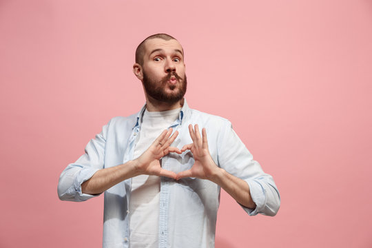 Portrait of attractive man with kiss isolated over pink background