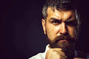 Closeup of male karate fighter hands. Cropped picture of handsome sportsman dressed in kimono for sambo, judo, jujitsu, karate and gesture with hand on dark background. Copy space for advertising.