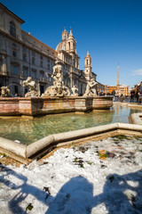 Fototapeta na wymiar A lovely day of snow in Rome, Italy, 26th February 2018: a beautiful view of Navona Square and Fontana dei Quattro Fiumi (Fountain of Four Rivers) under the snow