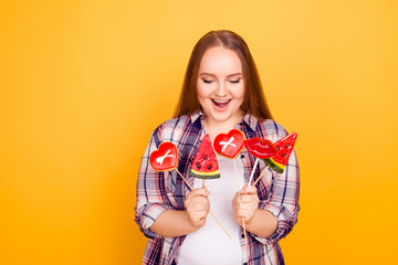 Young woman holds a variety of lollipops