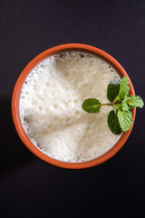 Lassie or lassi in terracotta glass - Lassi is an Authentic Indian cold drink made up of curd and...