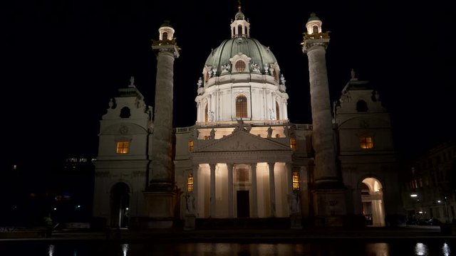close night shot of st charles church reflected in a pool at vienna, austria 