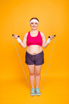 Young woman exercising with jump rope