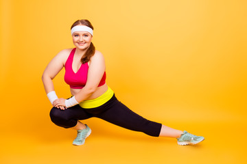 Young woman in exercise clothes doing lunge exercise