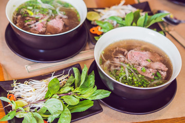 Pho Bo - Vietnamese fresh rice noodle soup with beef, herbs and chili. Vietnam's national dish