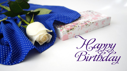 greeting card, white rose on blue fabric in white peas.inscription  "happy birthday".