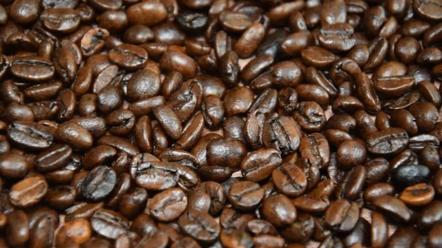 Roasted coffee beans, can be used as a background. Camera moves from left to right.