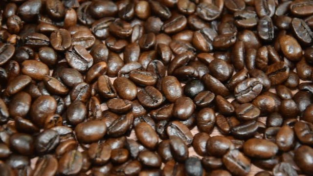 Roasted coffee beans, can be used as a background. The camera moves from right to left.