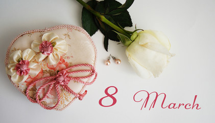 greeting card, White rose, earrings and casket on a white background the inscription 