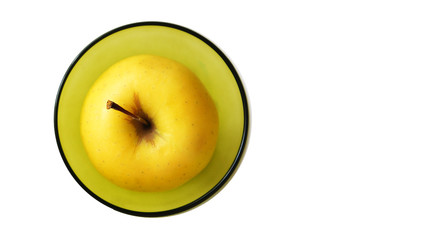 .yellow apple in a yellow bowl on a white background