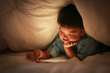 Kid using tablet for watch online cartoon.