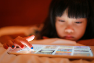 Kid finger tip touch on digital tablet device.