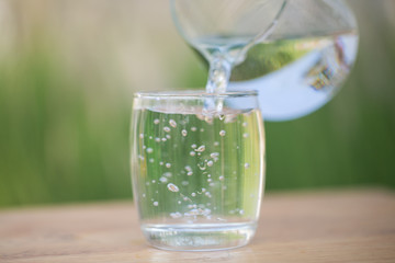 pouring water from a jug into a glass