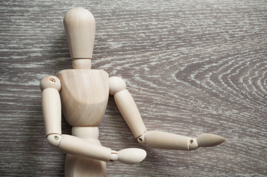 closeup of wooden mannequin on grey wooden background 