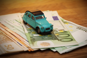 oldtimer toy on euro money