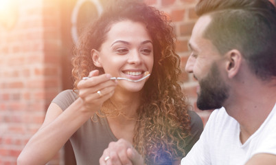 Young couple enjoying coffee at a street cafe and  laughing