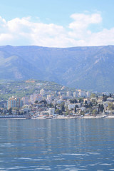 City at the foot of the mountains. View from the sea