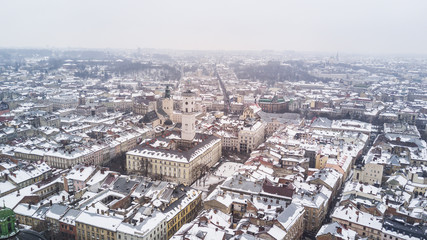 Fototapeta premium February, 2018 - Lviv, Ukraine. Top View of Lviv City Centre in snow from above in winter. Top view of city council.