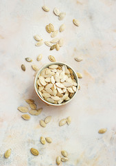 Pumpkin seeds in bowl isolated on white background