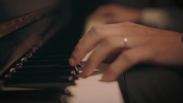 Super close up shot of professional pianist play soft and melodic tune on piano keyboard at hotel lobby, concert or private hearing during an event or performance of live music event