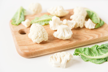 fresh cauliflower on the cutting board.white background.close-up view