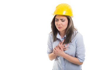 Portrait of female constructor holding her chest like hurting.