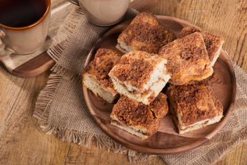 Overhead view of pieces of cinnamon swirl coffee cake on a wooden plate