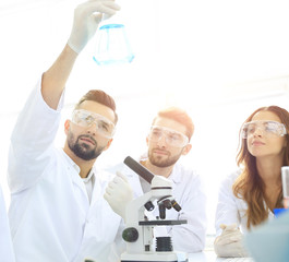 group of young workers are working in biochemistry lab,
