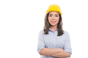 Portrait of female constructor standing with arms crossed.