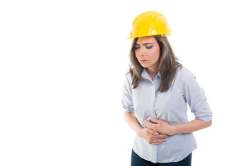 Portrait of female constructor holding her stomach.