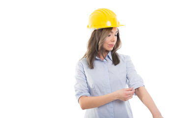 Portrait of female constructor arranging her sleeve.
