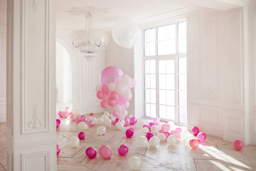 Luxurious living room with large window to the floor. Palace is filled with pink balloons
