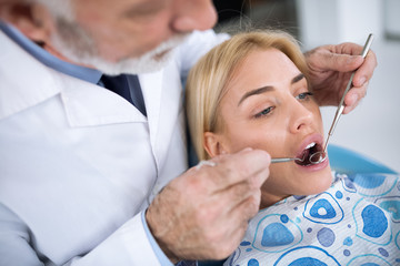 Dentist examining a patient's teeth in the dentist