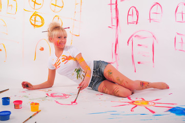 Beautiful young woman painter with paint brush in hands,