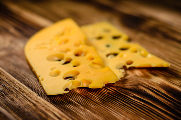 Sliced cheese on wooden table. Selective focus