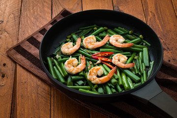 stir-fry Garlic chives with prawns and edamame on wood

