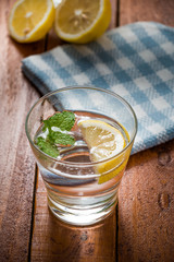 Lemonade with fresh lemon on wooden background


