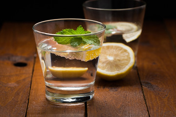 Lemonade with fresh lemon on wooden background


