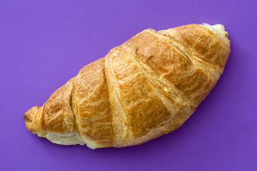 Croissant on violet background. Top view

